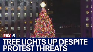 Rockefeller Christmas Tree lights up despite protest threats [upl. by Lesh]