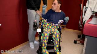 Strampler im Rollstuhl anziehen Guy with infantile cerebral palsy puts on romper suit  wheelchair [upl. by Nylcaj]