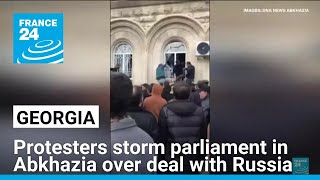 Protesters storm parliament in breakaway Georgian region Abkhazia over deal with Russia [upl. by Sidhu532]