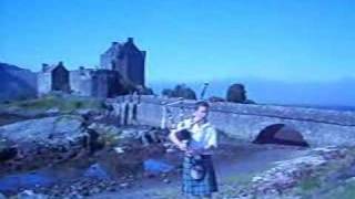 Scotland Highland Music  Bagpiper in front of the Eilean Donan Castle [upl. by Anoniw617]