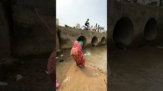 A woman catches fish from a large dam with a hook  amazing fishing in the canal  fishing shorts [upl. by Corty169]