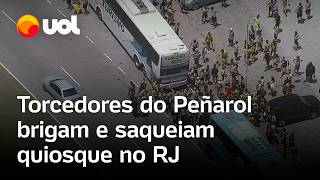 Torcedores do Peñarol brigam ateiam fogo em ônibus e saqueiam quiosque no Rio de Janeiro vídeo [upl. by Airetal772]