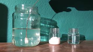 Nucleation point being introduced to a supersaturated solution of sodium acetate in water [upl. by Marley]