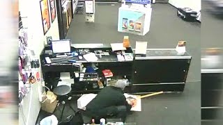 Caught on camera Boost Mobile store robbed at gunpoint [upl. by Sollars]