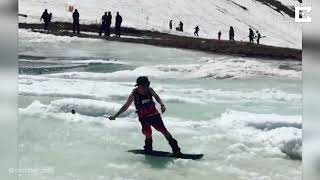 Snowboarder Fails At Skimming Across Ice Slush [upl. by Nofets]