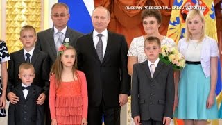 Vladimir Putin poses with quothappyquot families in awkward photos [upl. by Anod57]