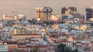 Aerial view of Lisbon skyline with Amoreiras shopping center towers timelapse from Almada at sunset [upl. by Ecnerrat256]