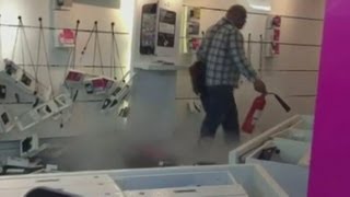 Man destroys inside of mobile phone shop in Manchester [upl. by Welcome601]