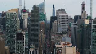 Aerial views capture a bustling New York City street filled with cars Modern skyscrapers tower over [upl. by Berte236]