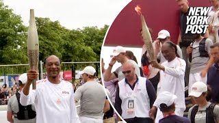 WATCH Snoop Dogg carries Olympic torch ahead of 2024 Opening Ceremony [upl. by Stanislaus236]