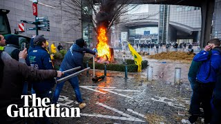 Protesting farmers light fires and clash with police at European parliament [upl. by Akehsat]