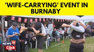 WifeCarrying Contest Held In Canada  WifeCarrying Competition In Canada  English News  News18 [upl. by Nirrol]