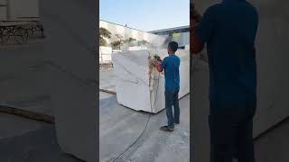 The worker is preparing work on the Calacatta Gold marble blocks before cutting them into big slabs [upl. by Nicholl]