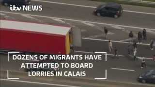 Migrants board moving lorries [upl. by Nus]