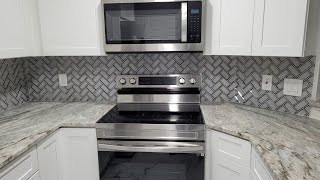 Herringbone Glass Tile Backsplash Installation [upl. by Neerak]