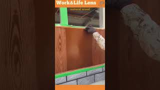 The worker uses a wood graining tool to mimic wood grain on a painted exterior wall [upl. by Loginov]