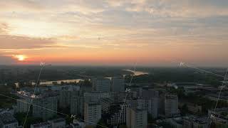 Aerial views showcase the sun setting over the Vistula River casting warm light on Warsaws skyline [upl. by Rann]