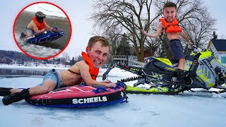 Water Skipping a Snowmobile While Pulling a Tuber New Polaris Snowmobile [upl. by Adroj596]