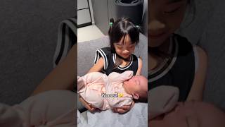 My 4 year old daughter carries a newborn for the first time 👶🍼 [upl. by Hesky]