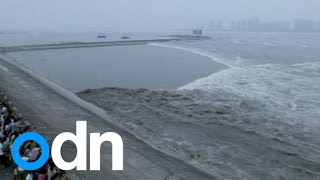 WATCH Spectacular tidal bore surges up Qiantang River in China [upl. by Freeman]