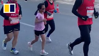 Man in China drops out of marathon letting daughter finish in his place [upl. by Brinkema396]