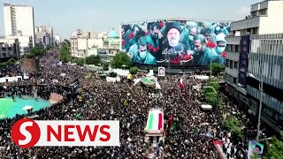 Iranian mourners march through Tehran streets bid farewell to president [upl. by Goodkin]