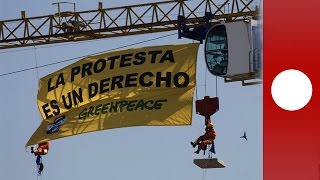 Greenpeace activists scale crane near Spanish Congress Madrid [upl. by Doak3]