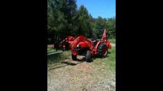 Kubota L4400 Tractor with Folk attachment lifting a tree up and into a fire pit [upl. by Aniweta]