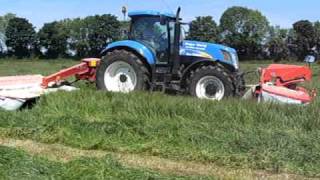 Mowing 2009 first cut silage with a new holland t7040 with double kuhn mowers [upl. by Bailie]