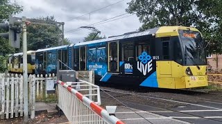 Manchester trams number 3023 and 3038 go through level crossing at Altrincham [upl. by Ileana]