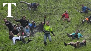 Daredevils chase cheese down steep hill in annual competition [upl. by Einitsed698]