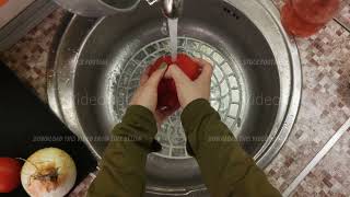 Pov of woman standing in the kitchen and washing ripe red bell pepper in the sink [upl. by Leva]