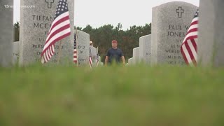 Volunteers place flags at the Veterans Cemetery in Suffolk [upl. by Leler]