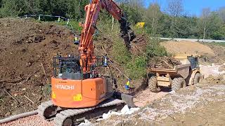 Hitachi 1357 loading Hydrema 912 with root trash [upl. by Darnell154]