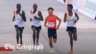 Runners appear to let Chinese contestant win Beijing halfmarathon [upl. by Ruenhs]