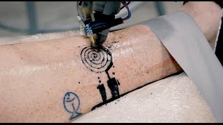 Getting a tattoo from an industrial robot looks intense Tomorrow Daily 404 [upl. by Mauer]