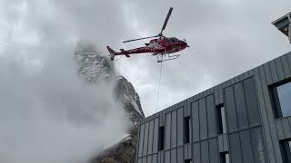 Helicopter picking up supplies at the Hornlihutte at 3260 meters on the side of the Matterhorn [upl. by Ailev]