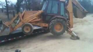 Loading a backhoe with no ramps [upl. by Naujaj446]