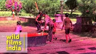 Children wet with coloured water during Holi festival [upl. by Karlik]