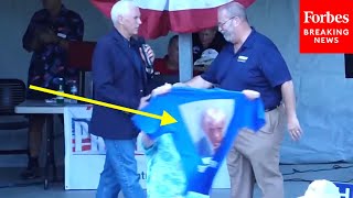 Trump Supporter Holds Up Mugshot TShirt As Mike Pence Takes Stage For New Hampshire Labor Day Event [upl. by Iam]