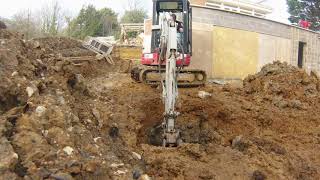 Digging manholes and drainage trenches with a Takeuchi TB23R Excavator [upl. by Icnan]