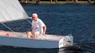 The Original Oz Goose PDGoose homebuilt sailboat passing a yacht in patchy breeze [upl. by Richers268]