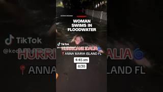 Woman swims in floodwater [upl. by Drahsir]