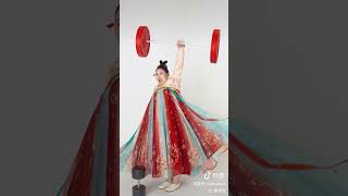 Chinese Olympic champion Li Wenwen shared a video of herself lifting weights in traditional costume [upl. by Dael]