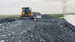 Bulldozers action pushing rock for filling in lake [upl. by Eisenhart]