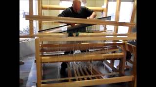 Using the reed to spread warp threads for loom weaving [upl. by Imerej]