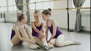 Emotional children are having rest after ballet lesson sitting on floor in light studio talking and [upl. by Maddock375]