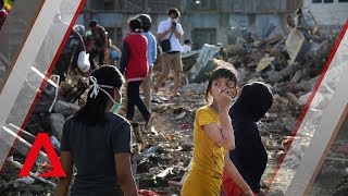 Sulawesi quake Searching for victims in the flattened village of Petobo [upl. by Ianteen]