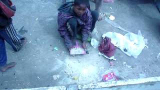 Madagascar Antananarivo street children sweeping for rice [upl. by Doolittle]