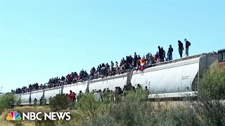 Mexico freight trains halts service after hundreds of migrants hitch rides to border [upl. by Nosnorb837]